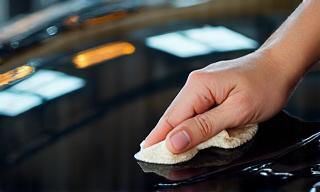 Applying wax and polish to a car bonnet for deep gloss